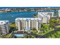 Aerial view of the condominium buildings with beautiful landscaping near the bay, including a parking area at 7872 Sailboat Key S Blvd # 602, South Pasadena, FL 33707