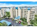 Multi-story condominium featuring a well-kept lawn, tropical landscaping, and ample parking at 7872 Sailboat Key S Blvd # 602, South Pasadena, FL 33707