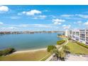 Scenic view of the water, a walkway, lush landscaping, and a multi-story condominium building at 7872 Sailboat Key S Blvd # 602, South Pasadena, FL 33707