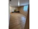 Empty living room with wood-look floors, a built-in shelf, and a window with blinds at 816 Drane Nw St, Plant City, FL 33563