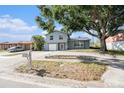 Daytime view of a charming two-story home with a well-maintained yard and ample parking space at 8212 Malvern Cir, Tampa, FL 33634