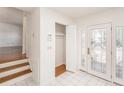 Bright foyer with decorative glass door, tile flooring, and closet space at 8212 Malvern Cir, Tampa, FL 33634