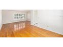 Open living space with hardwood floors and plenty of natural light from a large window at 8212 Malvern Cir, Tampa, FL 33634