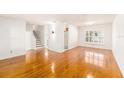 Spacious living room with hardwood floors, abundant natural light, and staircase access at 8212 Malvern Cir, Tampa, FL 33634