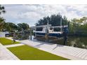 Modern boat dock with lift, showcasing waterfront living at its finest at 8706 Driftwood Dr, Tampa, FL 33615