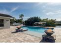 Beautiful backyard pool with a boat dock and cozy fire bowls, perfect for entertaining at 8706 Driftwood Dr, Tampa, FL 33615