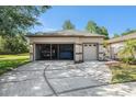View of garage with one door open, showcasing ample space for vehicles and storage at 7519 Berna Ln, Land O Lakes, FL 34637
