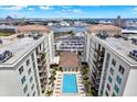 Overhead aerial shot of the apartment complex with a view of the pool and waterfront at 1238 E Kennedy Blvd # 702, Tampa, FL 33602
