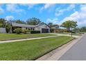 Well-maintained single-story home showcasing its manicured lawn, long driveway, and serene neighborhood setting at 14007 Middleton Way, Tampa, FL 33624