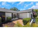 Inviting front entrance showcasing a brick walkway, manicured shrubs, and stylish exterior details at 14007 Middleton Way, Tampa, FL 33624