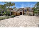 Elegant two-story home with a tile roof, three car garage and large brick paver driveway at 14809 Ninebark Ct, Land O Lakes, FL 34638