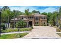 Elegant two-story home with a tile roof, well-maintained landscaping, and a spacious brick driveway at 14809 Ninebark Ct, Land O Lakes, FL 34638