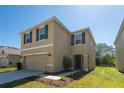 Beautiful two-story home with a two-car garage, an inviting front porch and manicured landscaping at 16810 Trite Bend St, Wimauma, FL 33598