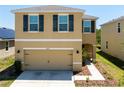 Attractive two-story home with a convenient two-car garage and meticulously maintained front yard at 16810 Trite Bend St, Wimauma, FL 33598