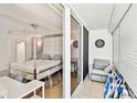 Bright bedroom with a luxurious bed frame, walkout balcony, and cozy seating area at 17940 Gulf Blvd # 9B, Redington Shores, FL 33708