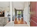 Inviting entryway featuring hardwood floors, decorative columns, and views of the dining room at 18533 Avocet Dr, Lutz, FL 33558