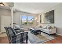 Cozy living room with hardwood floors, large windows, and neutral decor and plenty of natural light at 18533 Avocet Dr, Lutz, FL 33558