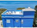 Aerial view of the rooftop deck with seating and ocean view at 228 Shore Dr, Tarpon Springs, FL 34689