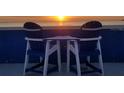 Seaside seating with a table offering the perfect sunset view at 228 Shore Dr, Tarpon Springs, FL 34689