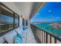 Enjoy water views from this condo's expansive balcony featuring comfortable seating and room for entertaining at 240 Sand Key Estates Dr # 58, Clearwater Beach, FL 33767
