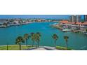 Scenic water view showcasing beautiful waterfront homes, boat docks, and lush tropical landscaping at 240 Sand Key Estates Dr # 58, Clearwater Beach, FL 33767
