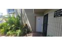 Exterior entrance to the building featuring lush landscaping and the unit number at 2424 W Tampa Bay Blvd # A106, Tampa, FL 33607