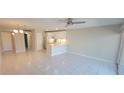 Open-concept living room with tile flooring, updated lighting, and a modern kitchen at 2424 W Tampa Bay Blvd # A106, Tampa, FL 33607