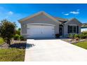 Single-story home with two-car garage, neutral color scheme and a well-maintained lawn at 25317 E Lenox Cir, Punta Gorda, FL 33950
