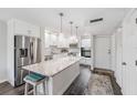 Modern kitchen featuring white cabinets, stainless steel appliances and a granite countertop island at 2621 Cove Cay Dr # 204, Clearwater, FL 33760