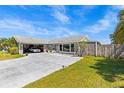 Charming single Gathering home featuring a well-manicured lawn and an open garage with a classic car at 2924 Catherine Dr, Clearwater, FL 33759