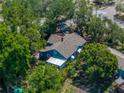Aerial view of a quaint home surrounded by mature trees and lush foliage at 3001 9Th N Ave, St Petersburg, FL 33713