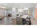 Modern kitchen featuring white cabinets, stainless steel appliances, and an island with seating at 3112 65Th N Way, St Petersburg, FL 33710