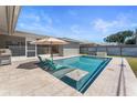 Backyard pool featuring crystal-clear water, lounge chairs, and an umbrella for sunny days at 3112 65Th N Way, St Petersburg, FL 33710