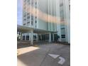 Exterior condo entrance featuring large awning and well maintained landscaping at 400 64Th Ave # 202, St Pete Beach, FL 33706