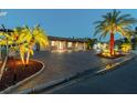 Beautiful one-story home exterior showcasing paver driveway, landscape lighting, and nighttime appeal at 4011 99Th W St, Bradenton, FL 34210