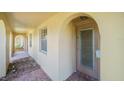 Covered porch with arched entryways, brick floor and front door at 4144 Hampton Dr # C, New Port Richey, FL 34652