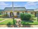 Inviting villa featuring manicured lawn and metal roof at 4144 Hampton Dr # C, New Port Richey, FL 34652
