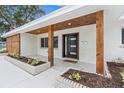 Inviting front porch with wood columns, modern front door, and lush landscaping at 4500 22Nd N Ave, St Petersburg, FL 33713