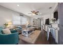 Comfortable living room features wood floors, ceiling fan, and lots of natural light at 4519 S Grady Ave, Tampa, FL 33611