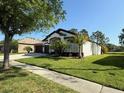 Beautiful home featuring a lush green lawn and mature landscaping at 5554 Riva Ridge Dr, Wesley Chapel, FL 33544