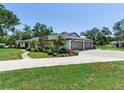 This lovely home features a three-car garage, beautiful landscaping, and a wrap around driveway at 6310 95Th E St, Bradenton, FL 34202