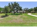 Charming single-story home with a well-manicured front yard and mature trees, offering curb appeal and shade at 6310 95Th E St, Bradenton, FL 34202
