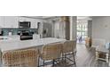 Modern kitchen with white cabinets, stainless steel appliances, and a large island with counter seating at 6712 Jennifer Dr, Temple Terrace, FL 33617