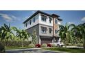 Striking modern home with a two-car garage, palm trees, and complementary landscaping at 721 Mandalay Ave, Clearwater Beach, FL 33767