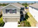 Charming two-story home with a well-maintained lawn, two-car garage, and coordinated exterior colors at 7486 Tuscan Bay Cir, Wesley Chapel, FL 33545