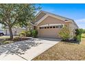 Charming single-story home with well-maintained lawn and a spacious two-car garage at 8704 Sandy Plains Dr, Riverview, FL 33578