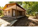 Rear of the house with a concrete patio area and access to the backyard at 907 Tyner St, Plant City, FL 33563