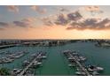 Picturesque marina view with boats docked, showcasing a tranquil waterfront setting with a colorful sunset at 9525 Blind Pass Rd # 904, St Pete Beach, FL 33706