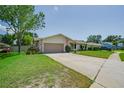 This ranch-style home features a two-car garage, stone accents, and a spacious driveway at 1104 Northridge Dr, Palm Harbor, FL 34683