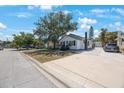 Well-kept home featuring a long driveway, lush trees and inviting facade at 1110 36Th N Ave, St Petersburg, FL 33704